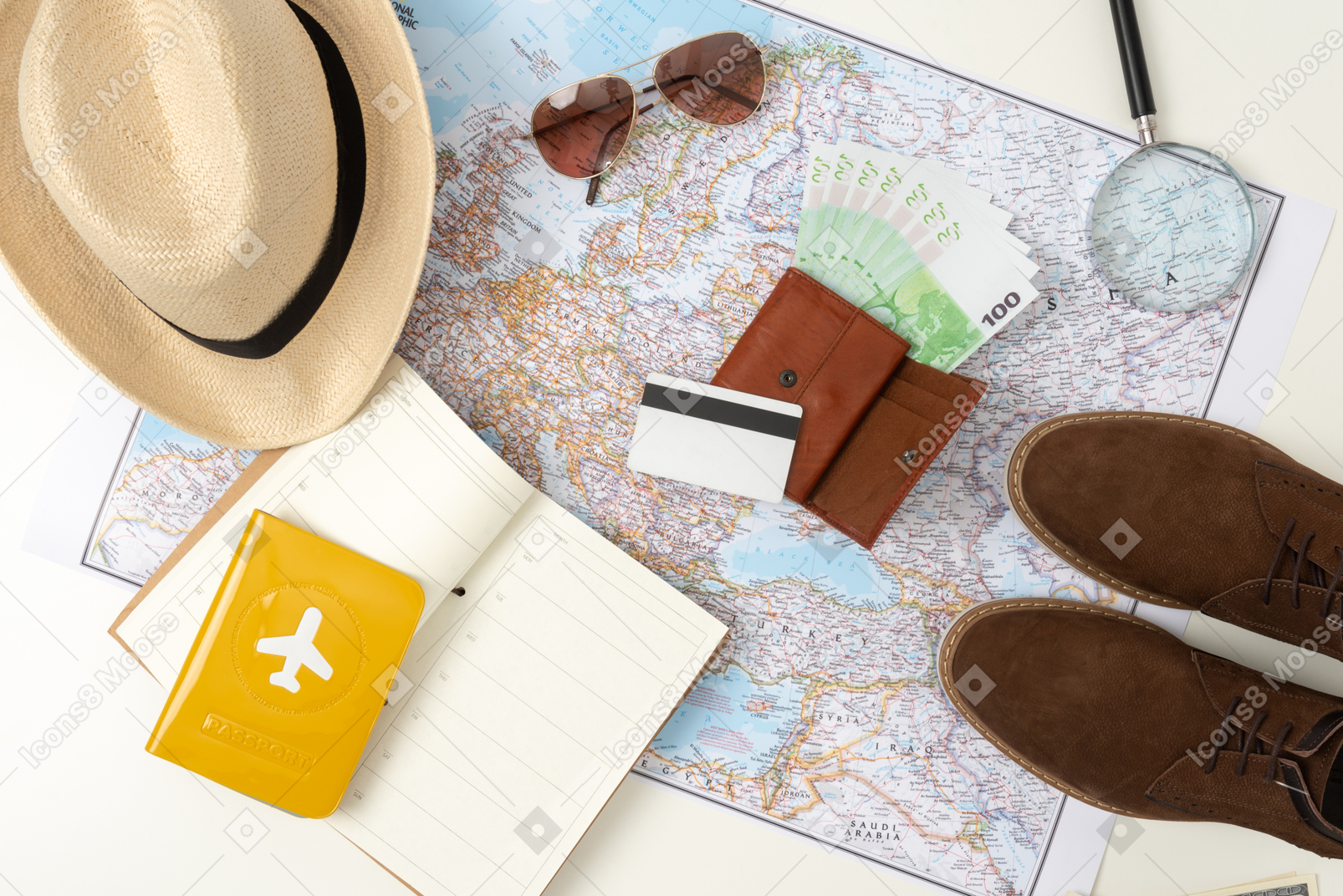 Sunglasses, straw hat, boots, international passport and a map with a tourist route lying around the only thing that can replace them all: money