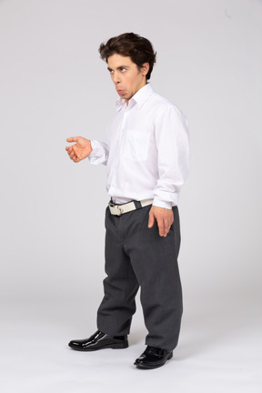 Young man in white shirt and grey trousers