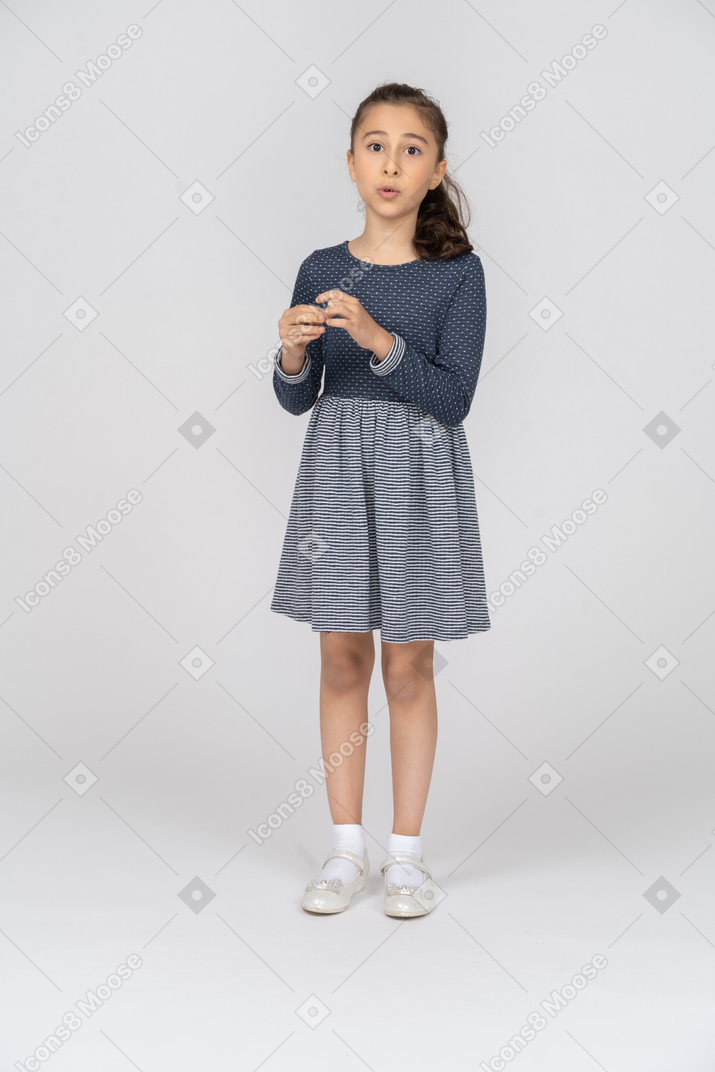 Front view of a girl fiddling with her fingers while talking