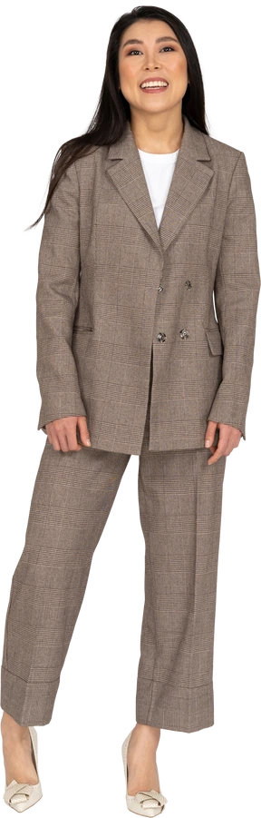 Front view of a smiling young lady in brown business suit