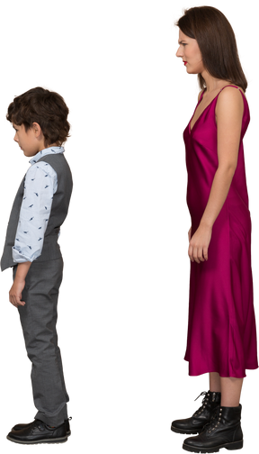 Disappointed woman in red dress with boy standing in profile