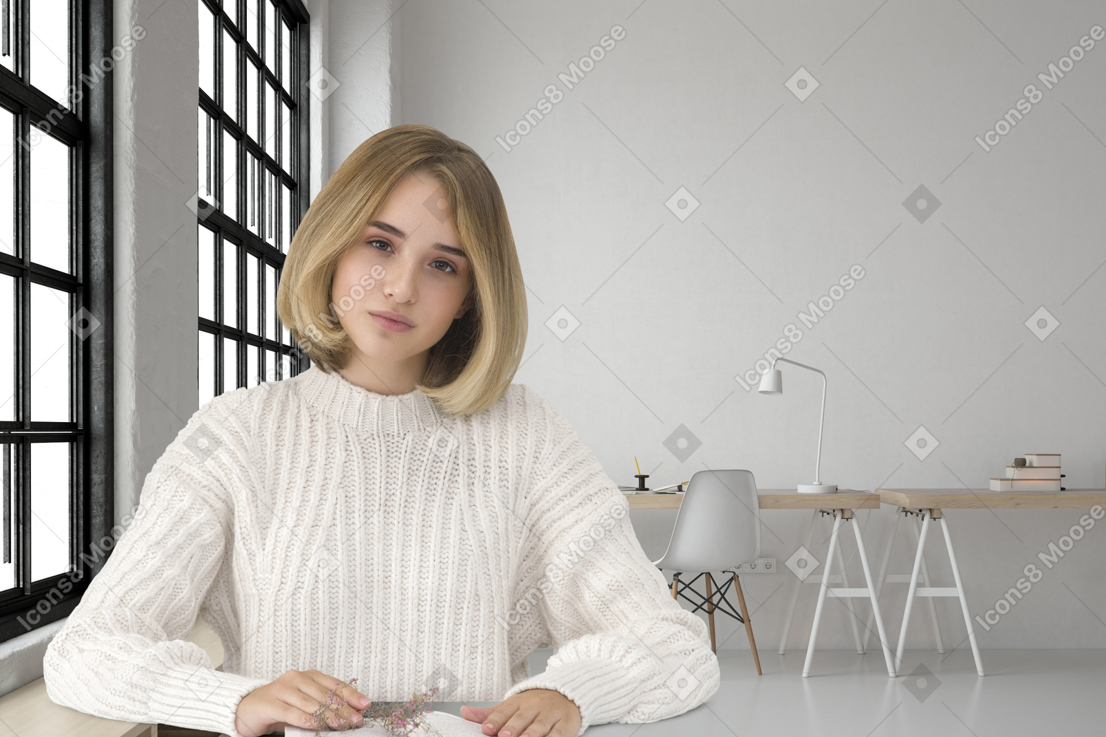 A woman sitting at a table with a book