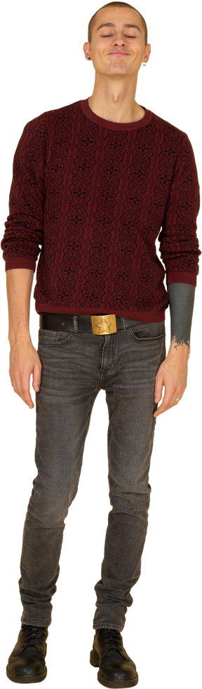 Front view of a funny grimacing young man in read sweater