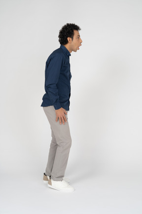 Side view of an impressed man in casual clothes