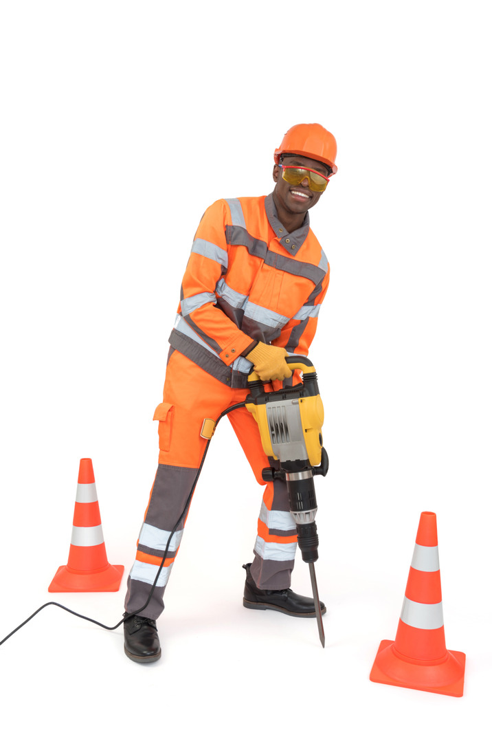 Road worker repairing a pavement