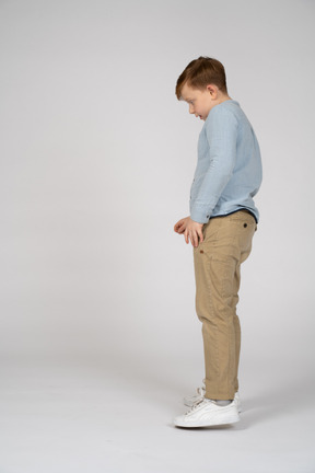 Profile of boy in pants and shirt