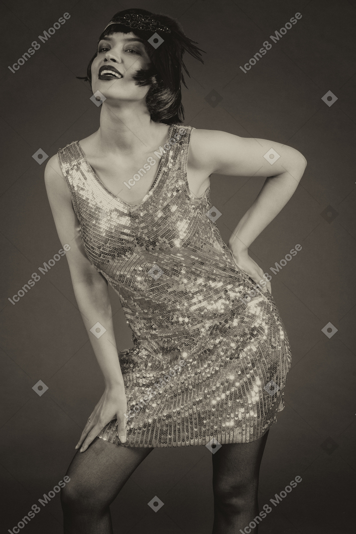 Sensual retro-styled female posing in sequin dress
