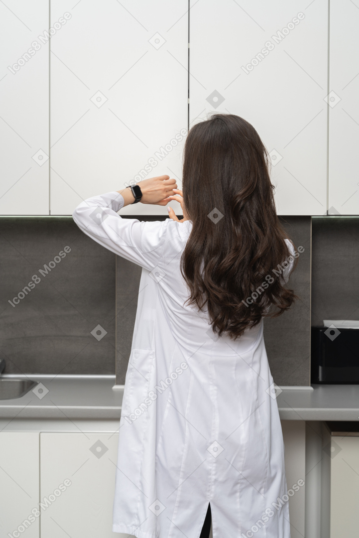 Female scientist looking at her smartwatch