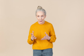 Elegant older woman in a mustard sweater