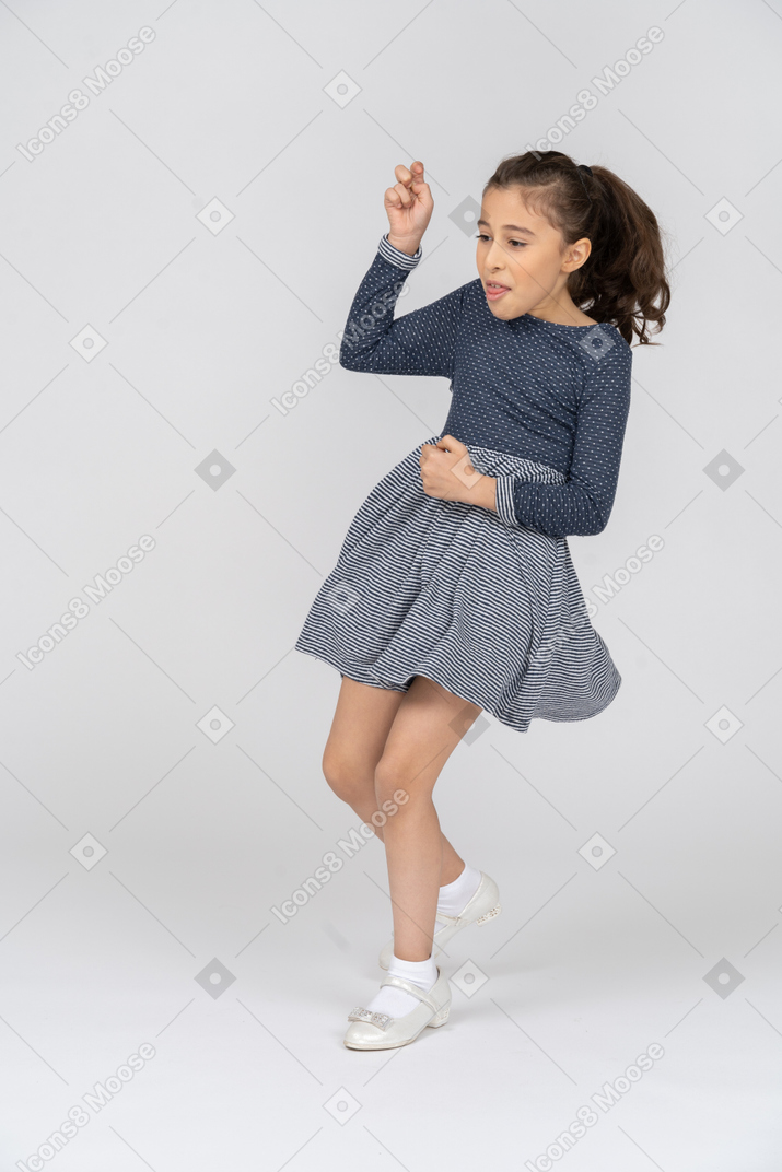 Three-quarter view of a girl dancing funnily