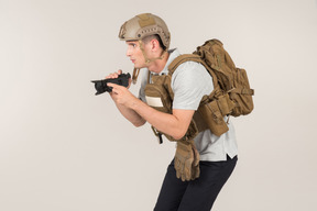 Male hot zone journalist in bulletproof vest hunting for a shot