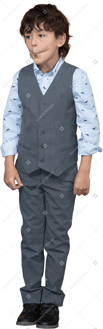 Front view of a cute boy in suit making faces