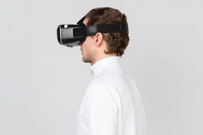 Side view of young man in virtual reality headset