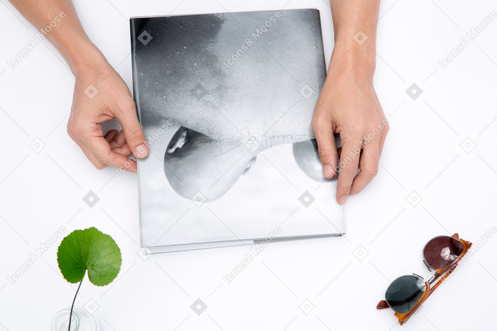 Male hands holding a photo album