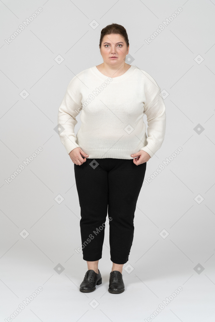 Sad plump woman in casual clothes looking at camera