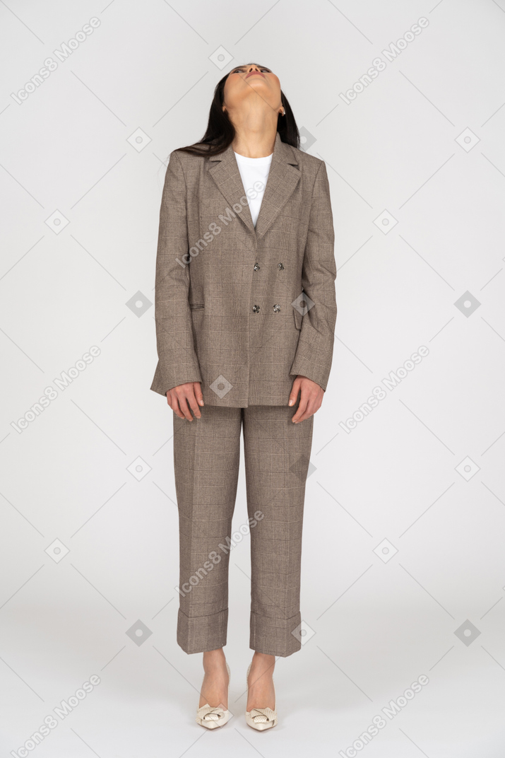Front view of a young lady in brown business suit throwing head back