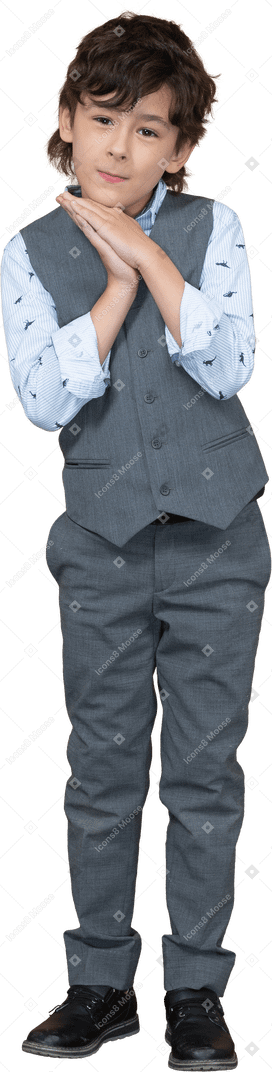 Front view of cute boy in grey suit looking at camera