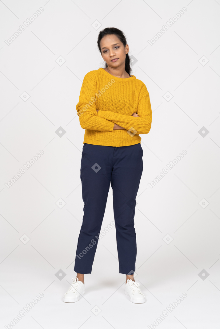 Front view of a girl in casual clothes posing with crossed arms