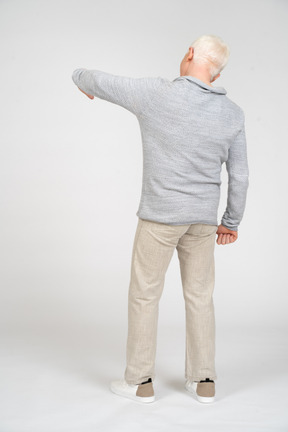 Rear view of man gesturing with hand