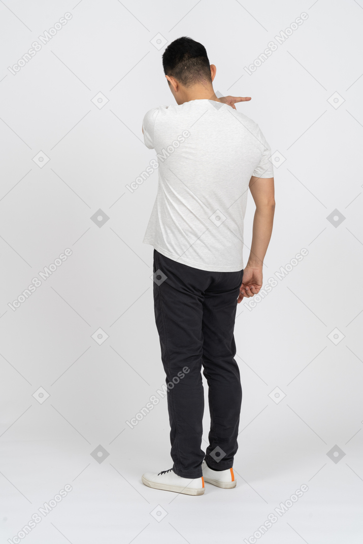 Back view of a man in casual clothes pointing at something