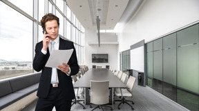 A man in a suit holding a piece of paper