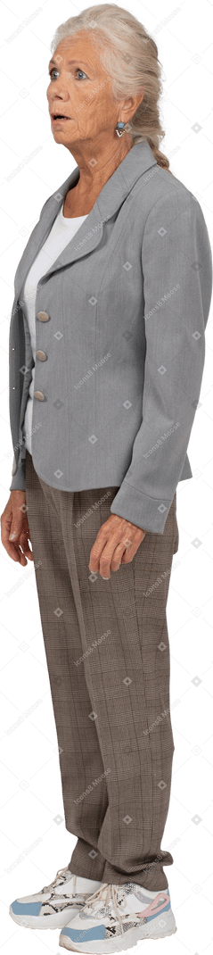 Side view of an impressed old lady in suit