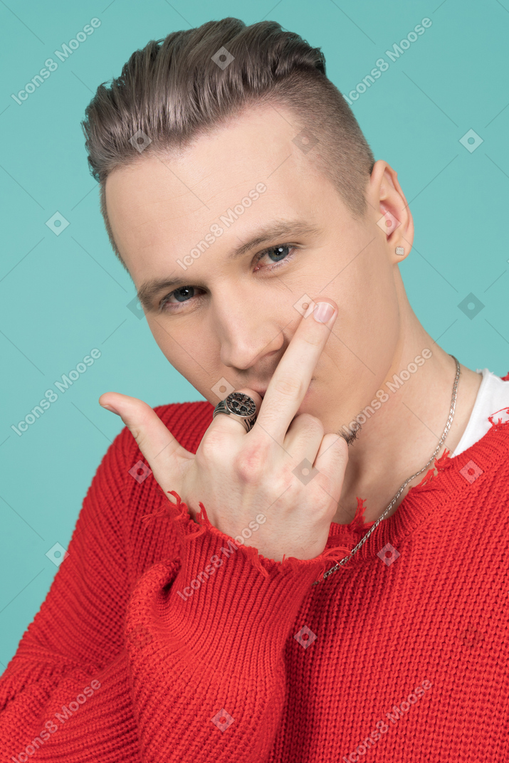 Barefaced young man making rude gesture