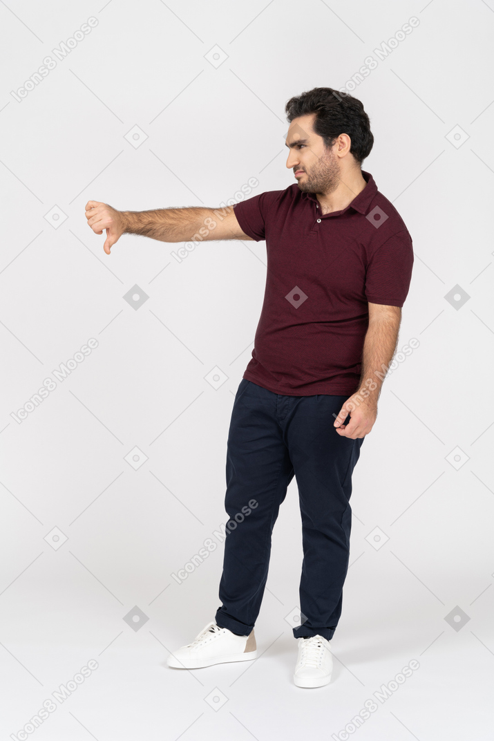 Side view of disgruntled man pointing his thumb down