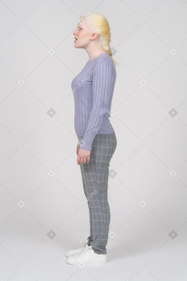 Side view of a confused woman standing