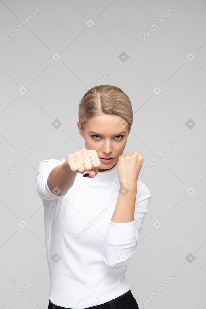 Young beautiful woman showing her fists