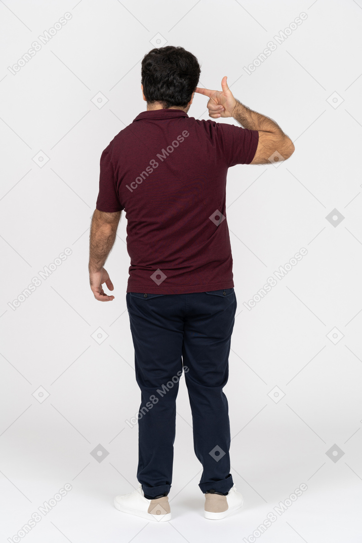 Vista traseira de um homem apontando uma arma de dedo na cabeça