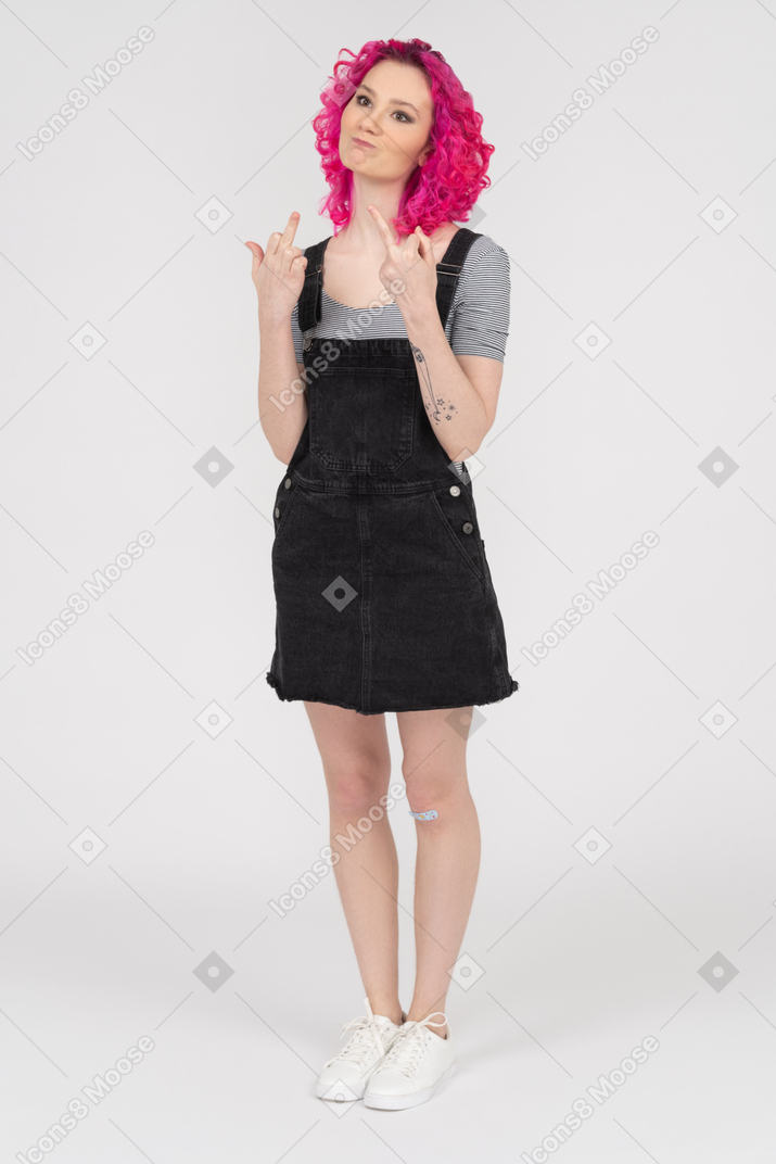 Expressive girl showing middle fingers with both hands