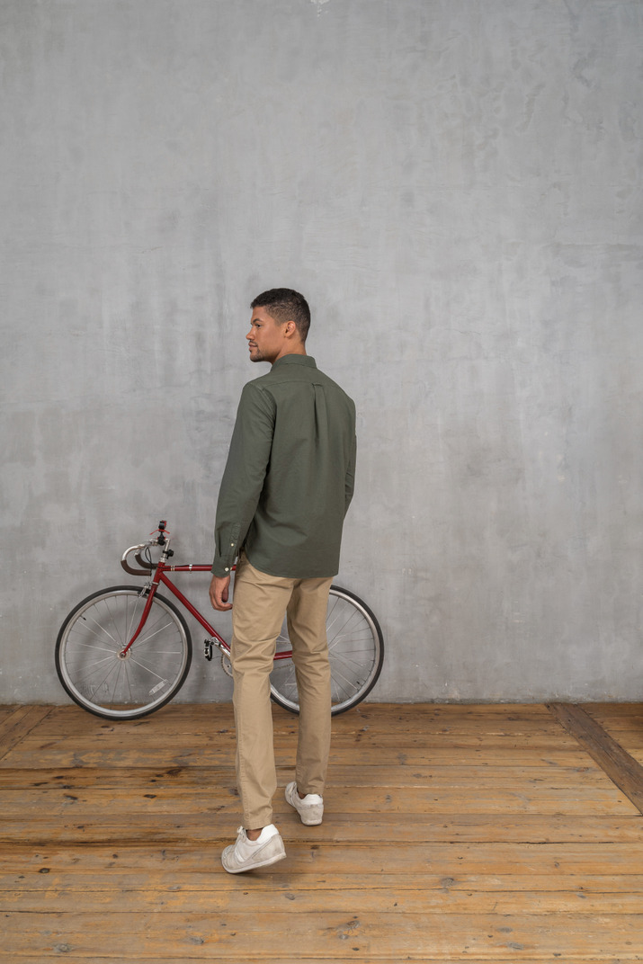 Man standing next to a bicycle