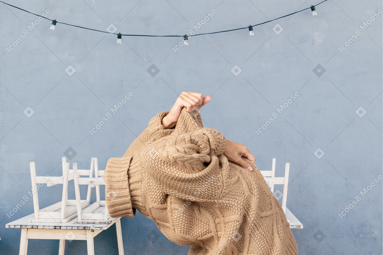A woman taking off a sweater