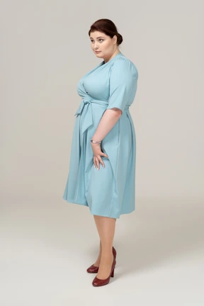 Side view of a woman in blue dress