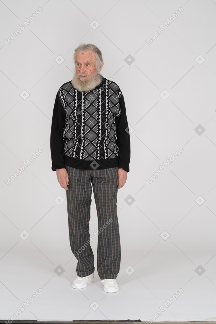 Front view of elderly man standing and looking aside
