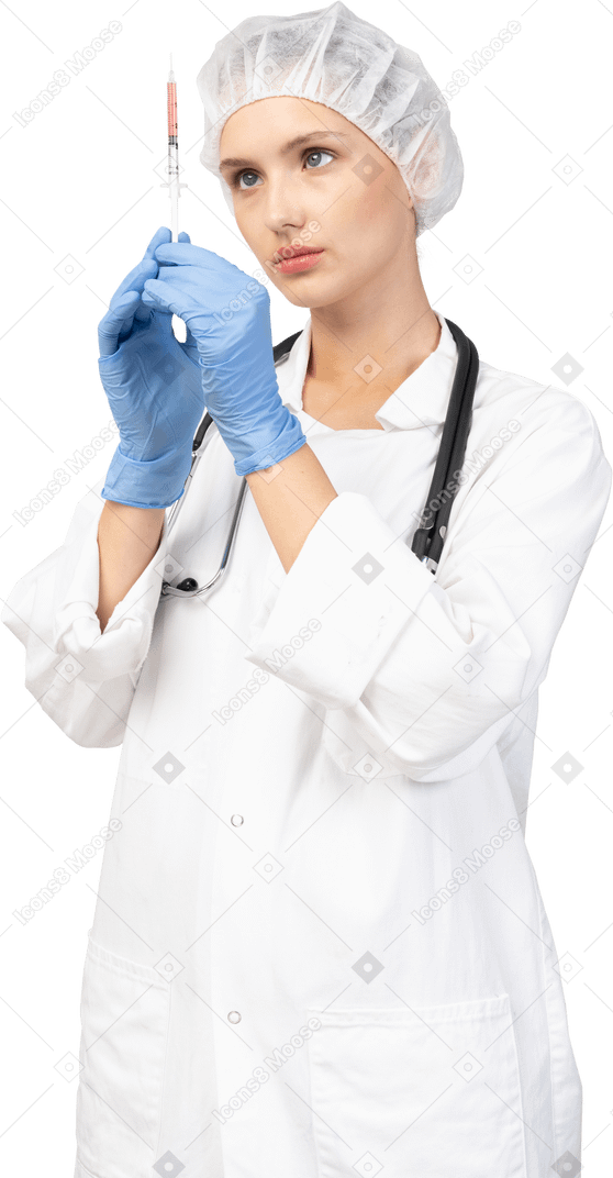 Front view of a young female doctor holding a syringe