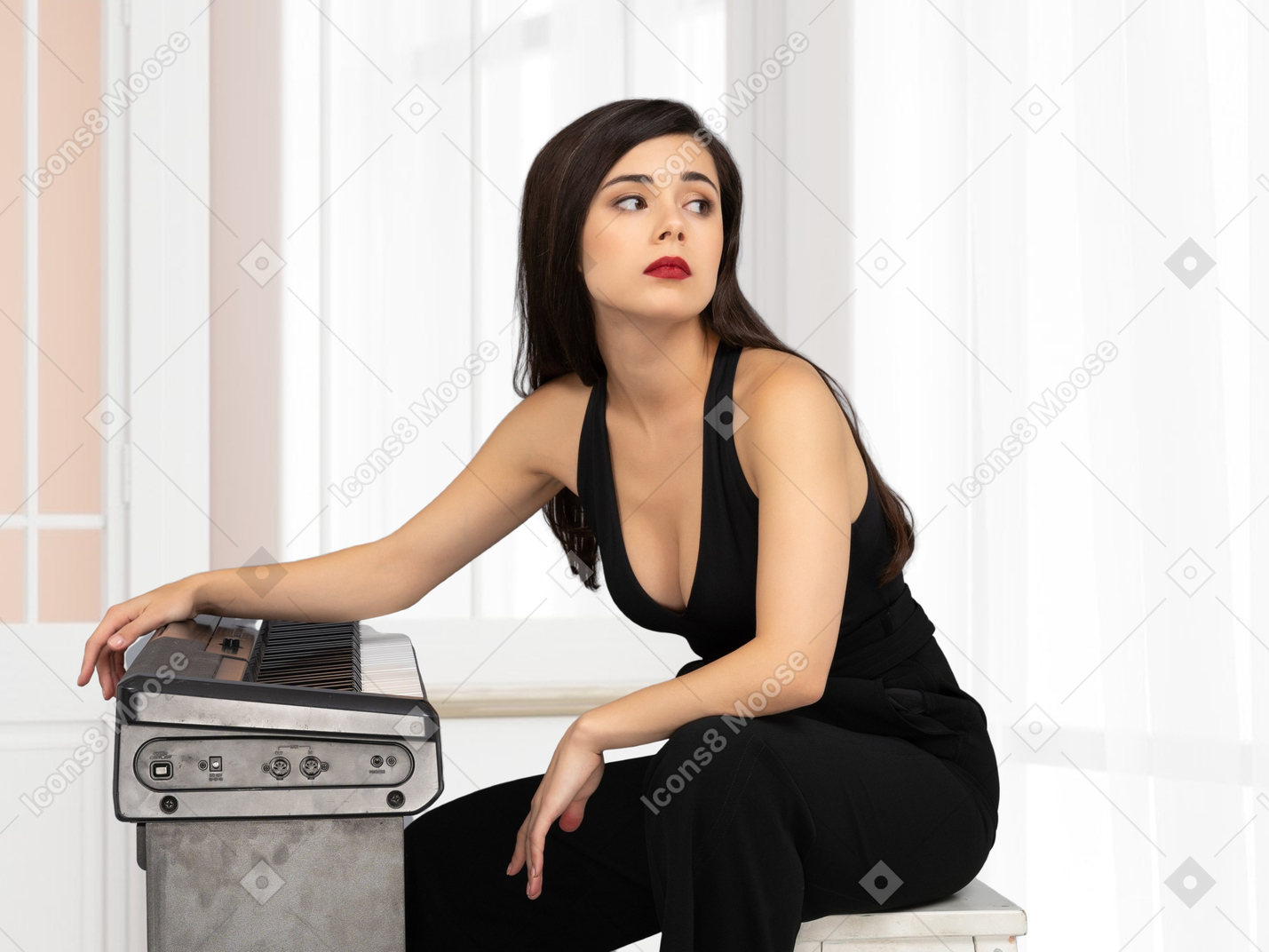 Woman sitting near synthesizer