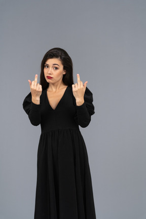 Front view of a mad young lady showing middle fingers
