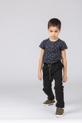 Front view of a cute boy walking forward