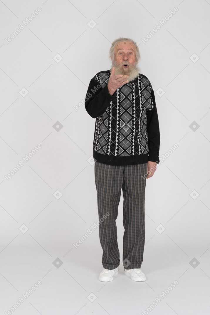 Front view of an old man holding hand up and looking shocked