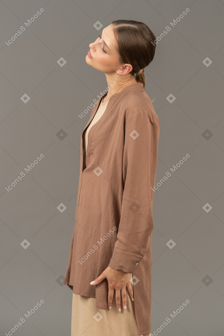 Side view of a woman tilts her head on the right