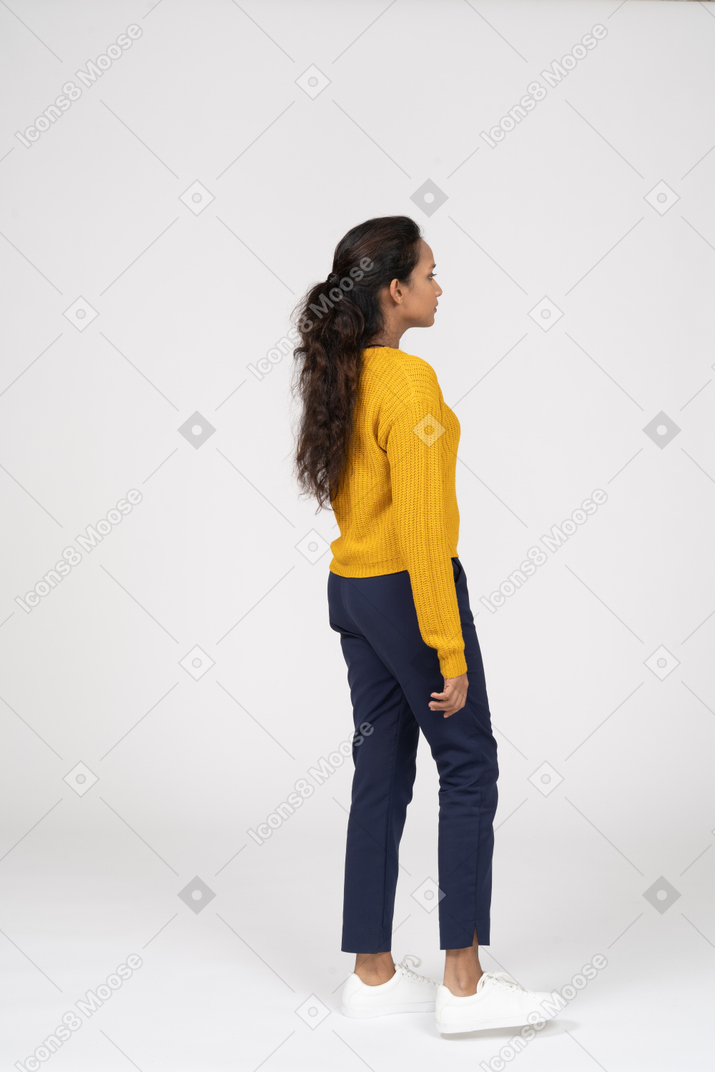 Girl in casual clothes standing in profile