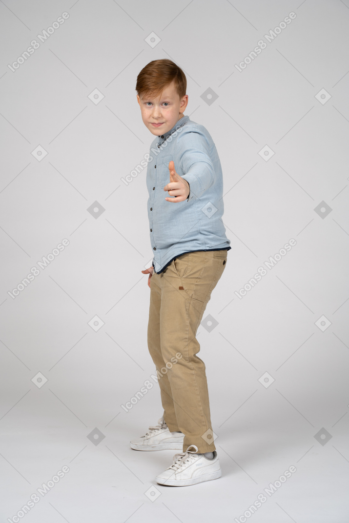 Boy pointing at camera