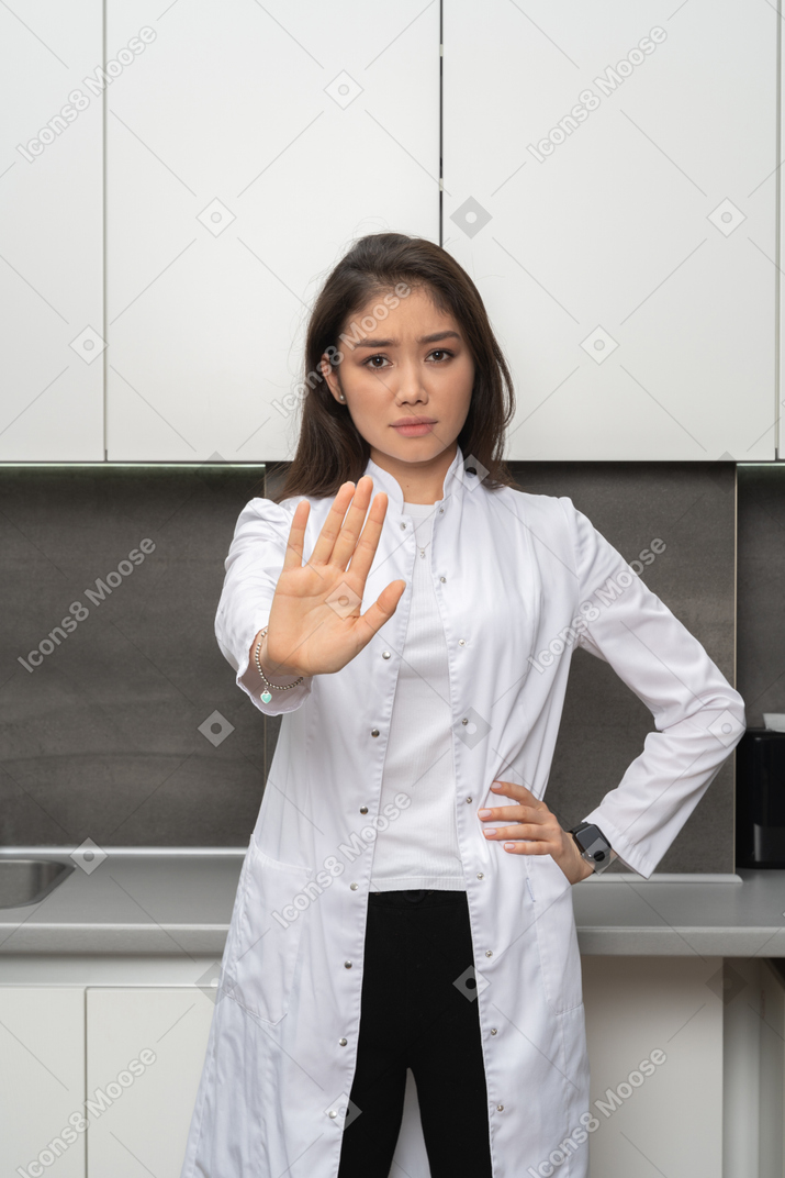 Close-up a female nurse showing a stop gesture