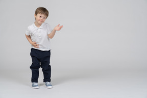 Smiling little boy raising his arm