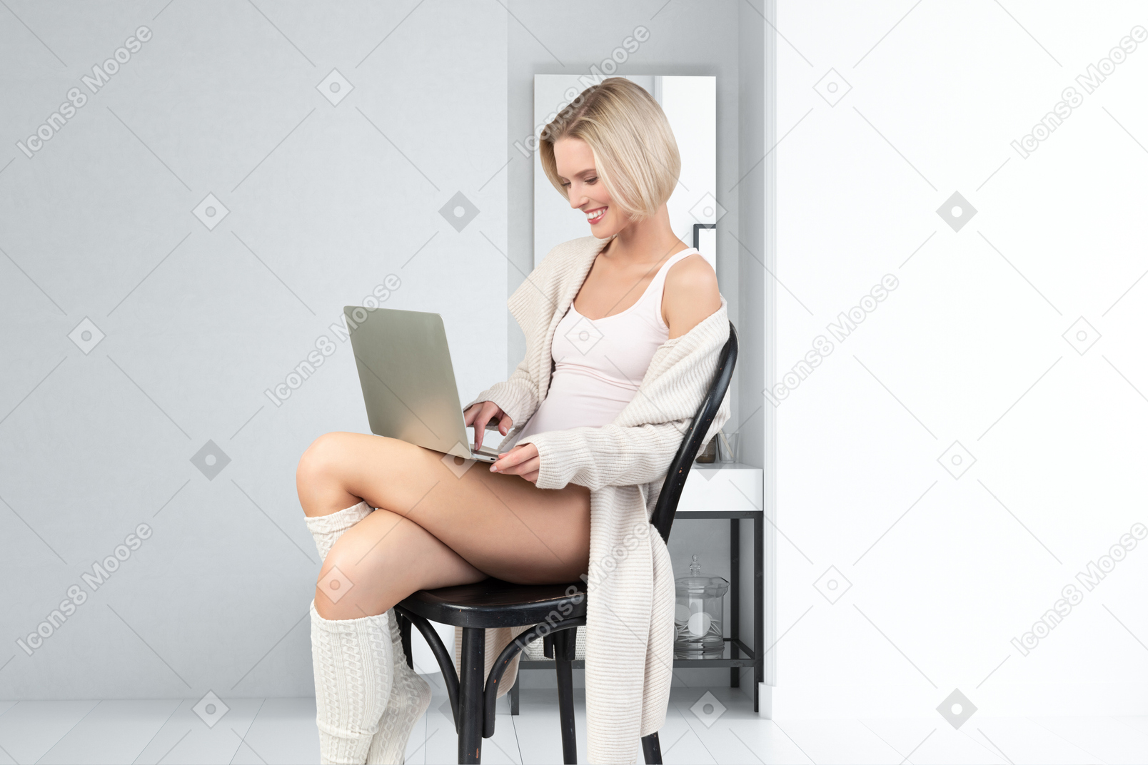 A woman sitting on a chair using a laptop computer