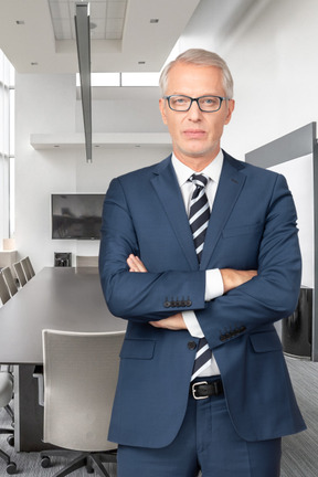 A man in a suit and tie standing in an office