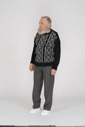 Elderly man in dark clothes standing still