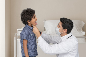 A young boy is being examined by a doctor